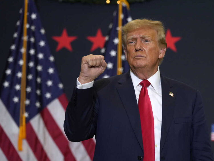 Former President Donald Trump reacts to supporters during a commit to caucus rally, Tuesday, Dec. 19, 2023, in Waterloo, Iowa. (AP Photo/Charlie Neibergall)