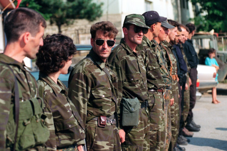 UCK or KLA (Kosovo Liberation Army) as translated in english, stand in formation to turn over weapons to Marines from the 26th MEU in the village of Zegra, Kosovo.  The Marines and sailors of the 26th Marine Expeditionary Unit (MEU) are helping to enforce the implementation of the military technical agreement and to provide peace and stability to Kosovo during Operation JOINT GUARDIAN.