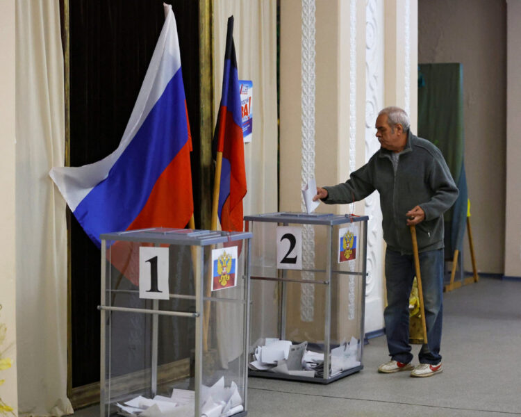 A voter casts his ballot at a polling station during local elections held by the Russian-installed authorities in the course of Russia-Ukraine conflict in the settlement of Panteleimonivka in the Donetsk region, Russian-controlled Ukraine, September 10, 2023. REUTERS/Alexander Ermochenko