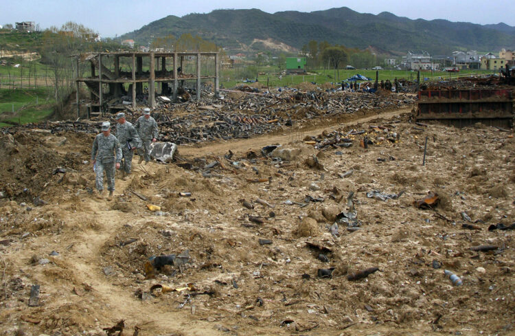 Members of a U.S. European Command Humanitarian Assistance Survey Team examine damage caused by a March 15 series of explosions at a weapons demilitarization facility in Gerdec, Albania, April 8.  The HAST, including specialists in environmental science, engineering, explosive ordnance disposal, civil affairs and mortuary affairs, assisted Albanian citizens and military and government officials in the aftermath of a disaster that killed 22 people and destroyed more than 400 homes. (Photo by Sgt. 1st Class Steve Chenault)