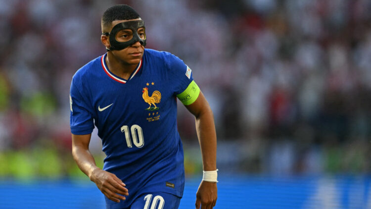 France's forward #10 Kylian Mbappe, wearing a protective mask, looks on during the UEFA Euro 2024 Group D football match between France and Poland at the BVB Stadion in Dortmund on June 25, 2024. (Photo by OZAN KOSE / AFP)
